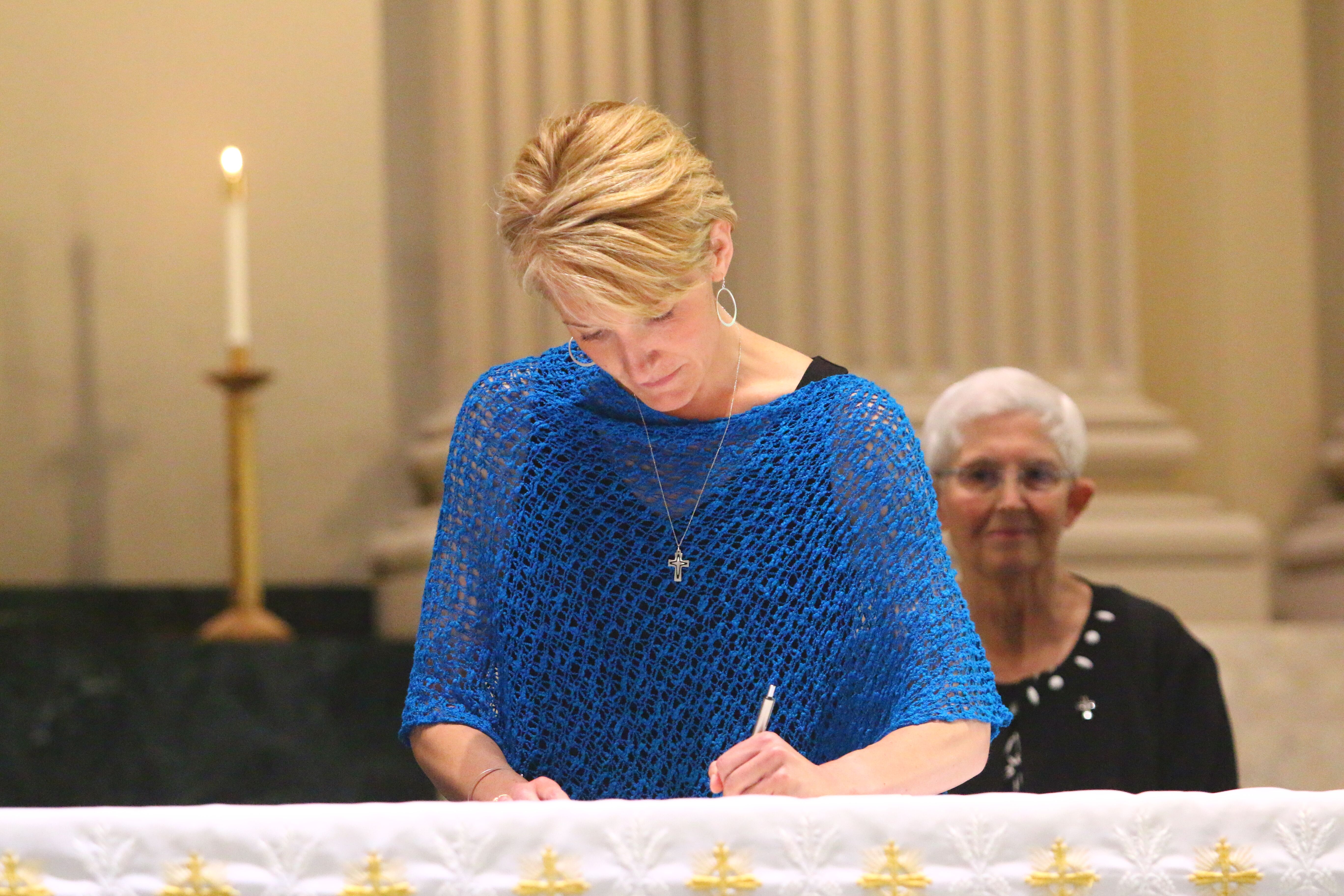 Danielle-signing-vows